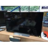 Toshiba flatscreen television model number 43UL5A63DB with remote control
