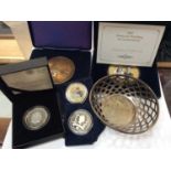 Pierced silver dish, together with Commemorative coins including Prince of Wales £5 silver proof coi