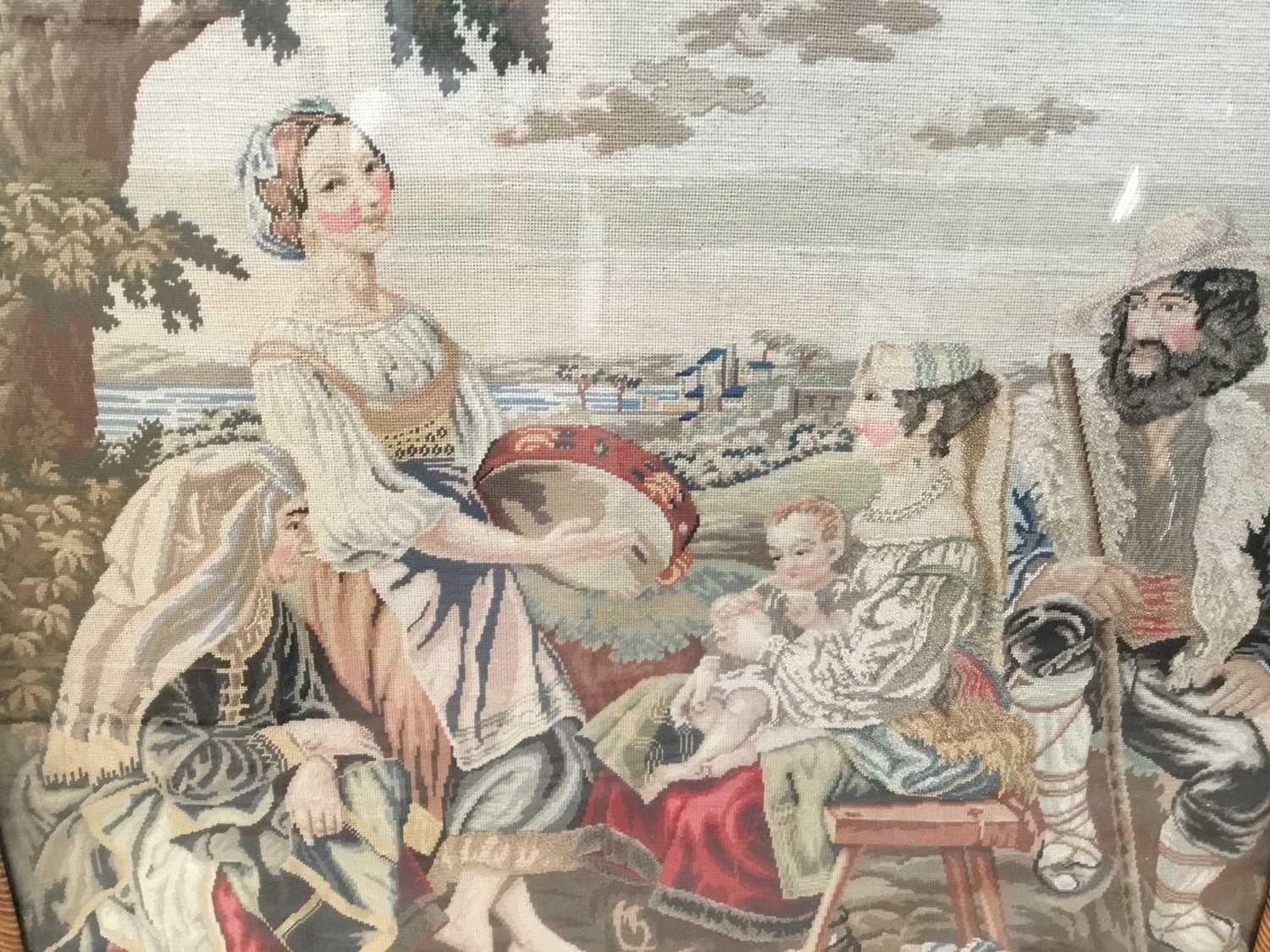 Antique needlework panel depicting a family group being entertained by a musician, 66cm x 60cm, in m