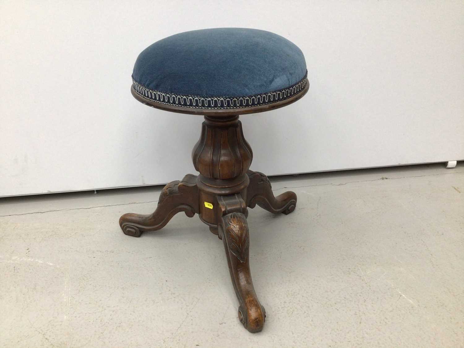 Victorian mahogany piano stool with blue upholstered seat on tripod base and a tiled top table and a