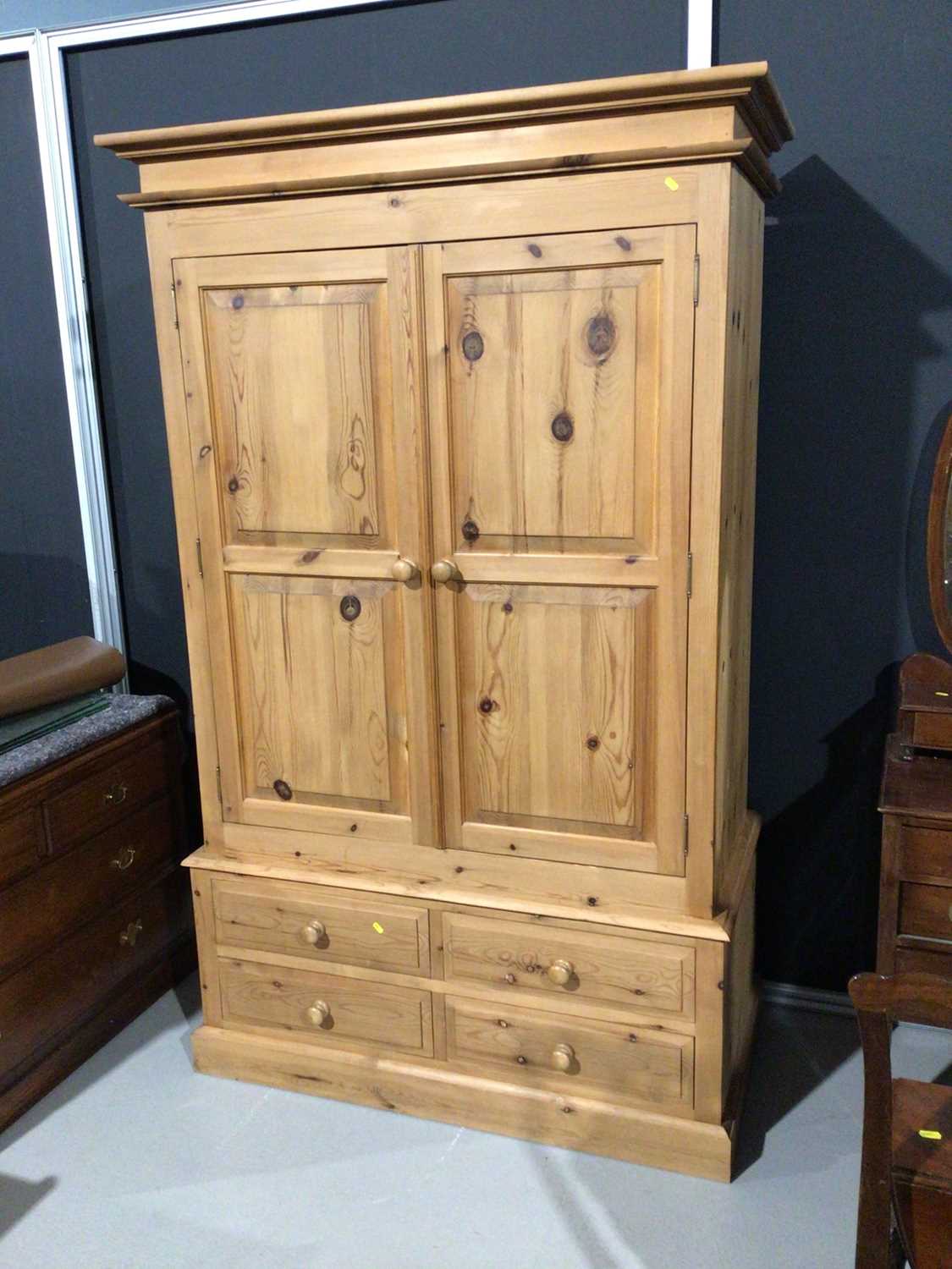 Modern pine double wardrobe with two panelled doors and four short drawers below, 128cm wide x 63cm