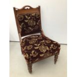 Edwardian walnut framed easy chair with upholstered seat and back on turned front legs and castors