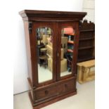 Victorian mahogany double wardrobe with two arched mirror doors and drawer below, 127cm wide x 57cm
