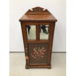 Edwardian walnut pot cupboard with ledge back, two bevelled mirror plates and painted door below, 45