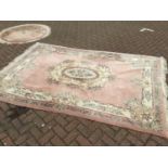 Chinese wash rug with floral decoration on peach ground 274cm x 186cm with a smaller round rug of si
