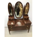 Edwardian mahogany sunk centre dressing table with raised triple mirror back and four drawers below,