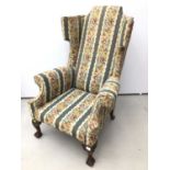 Good quality Georgian style wing back armchair with floral upholstery on carved mahogany legs with c