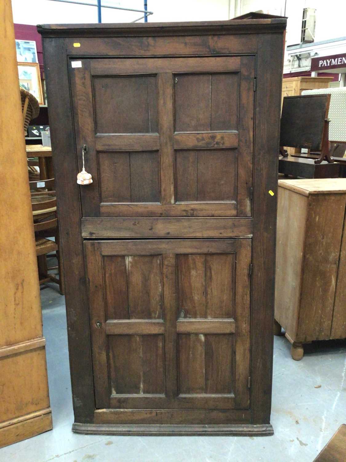 Early 19th century oak two height corner cupboard with panelled doors 183 cm high, 96 cm wide