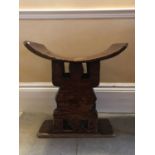 Antique African Tribal seat with carved stylised turtle supports and dished seat, on rectangular bas