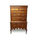 George I solid walnut chest on stand, the moulded cornice above a frieze drawer, two short and three