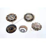 Five brooches to include two early Victorian seed pearl and black enamel mourning brooches