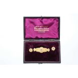 Pair of Victorian 9ct gold earrings and brooch en-suite, the target shape cluster earrings set with