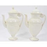 Pair of 19th century creamware coffee pots, the handles with flower and leaf terminals, the covers w