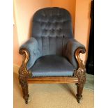 William IV rosewood framed easy chair with buttoned blue velvet upholstery, the carved scroll arms a
