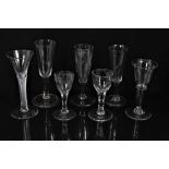 Seven Georgian drinking glasses, including an air twist stem glass, three plain stem, two faceted st