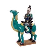 Unusual Chinese ceramic model of a camel and rider, late Qing period, painted in turquoise, yellow,