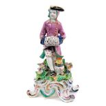 Bow porcelain figure of Winter, circa 1765, modelled as a seated gentleman with his hands in a muff,