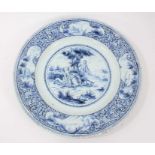 19th century Dutch blue and white Delft charger, painted with a figural scene, the edge with landsca