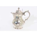 Victorian silver plated hot water jug of baluster form, with chased scroll and foliate decoration