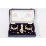 George II silver caster and pair George III salts in an associated case.