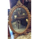 Gilt wall mirror, the oval plate in foliate surround, 137cm high x 85cm wide