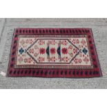 Modern Persian-style rug with red and blue geometric pattern on cream ground, approximately 185cm x