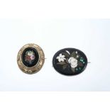 Two 19th century pietra dura brooches, one with oval panel depicting summer flowers in a gilt metal