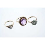 Three rings to include a diamond cluster ring, emerald and diamond cluster ring and an amethyst sing