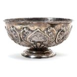 Late Victorian silver bowl of circular form, with raised scroll and floral decoration