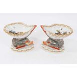 Pair of Berlin porcelain salts, of shell form, painted with exotic birds and insects, supported by m