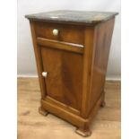Late 19th century Continental walnut bedside cupboard, the marble top above a single drawer and cupb