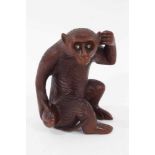 Japanese carved wooden okimono of a monkey holding a gourd, 10cm high