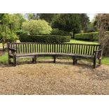 Large teak garden bench of semi-circular form, approximately 350cm wide