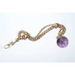 Victorian yellow metal three strand watch chain with amethyst sphere fob