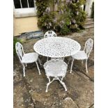 Victorian-style white painted metal garden table and four matching chairs, the table top with pierce