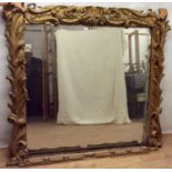 Impressive 19th century gilt overmantel mirror, with rectangular plate within heavily carved folate