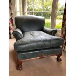 Good quality Howard & Sons low armchair, upholstered in blue/green leather with loose seat, on carve