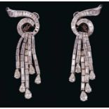 Pair of Art Deco style diamond pendant earrings with a stylized waterfall design, the baguette cut d