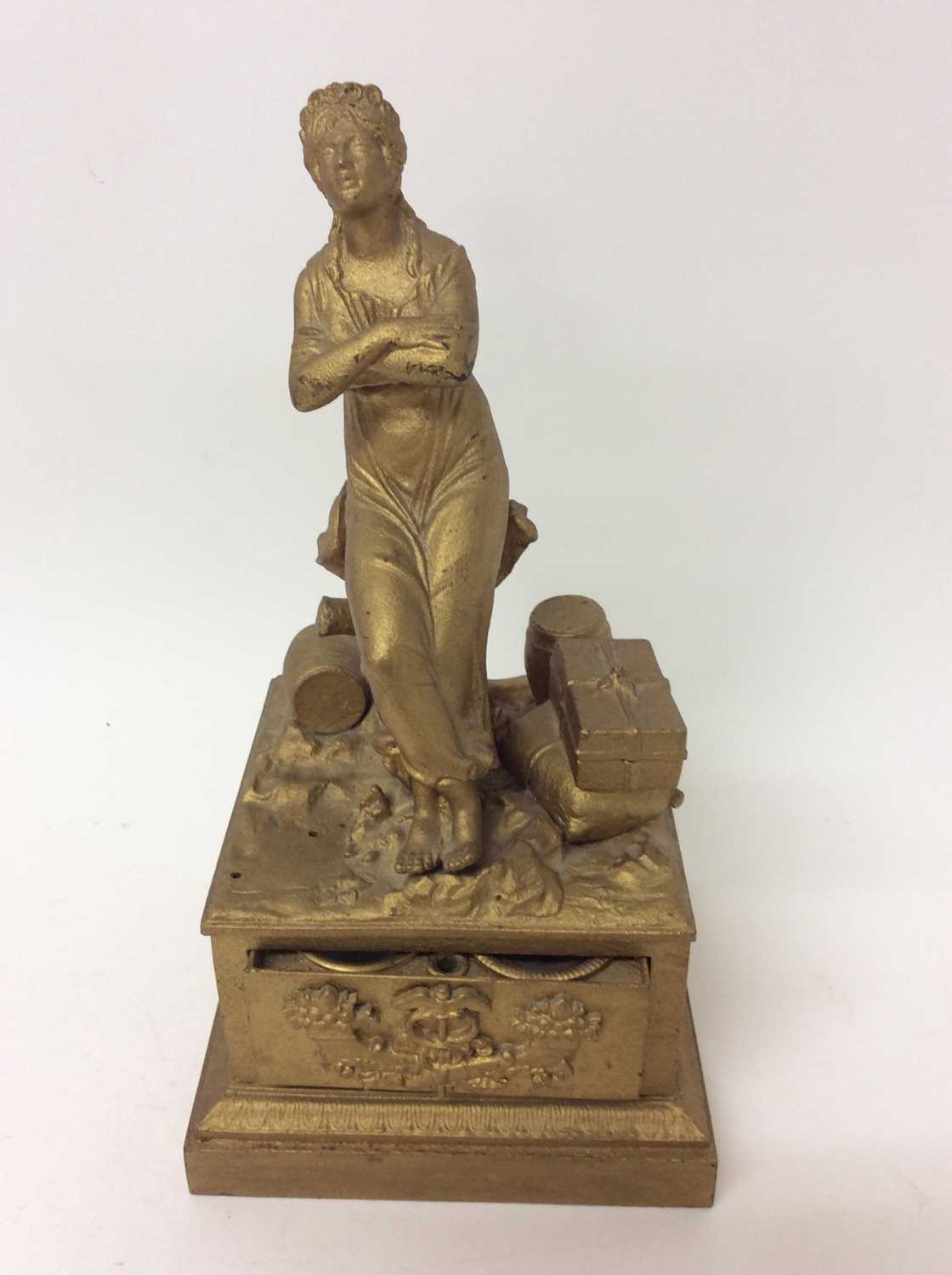 19th century Continental inkstand of classical form depicting figure sitting on tree stump