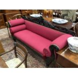 Regency mahogany framed double ended sofa upholstered in red fabric, the carved mahogany frame with