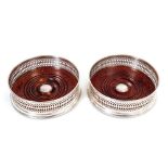 Pair contemporary silver wine coasters of circular form, with pierced decoration,
