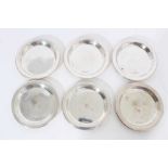 Set of six contemporary silver wine glass coasters of circular form.