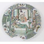 Chinese Kangxi period famille verte dish, painted with an interior scene with figures and attendants