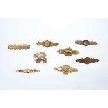 Eight Victorian gold brooches to include Etruscan Revival