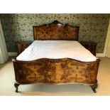 Early 20th century walnut bedstead, the carved and shaped headboard with reeded pillars, serpentine