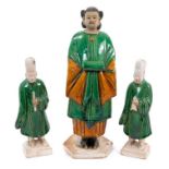 Three Chinese Sancai-glazed pottery figures, probably Ming dynasty, including a pair of smaller male