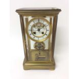 Late 19th century French brass four glass mantle clock with key and pendulum