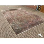 Large Persian carpet with geometric decoration on red, blue and cream ground 410cm x 630cm