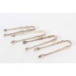 4 pairs of George III silver sugar tongs, with bright cut engraved decoration,