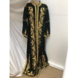 Women's green velvet full length coat with embroidered abstract scrolling foliage. Knotted button a